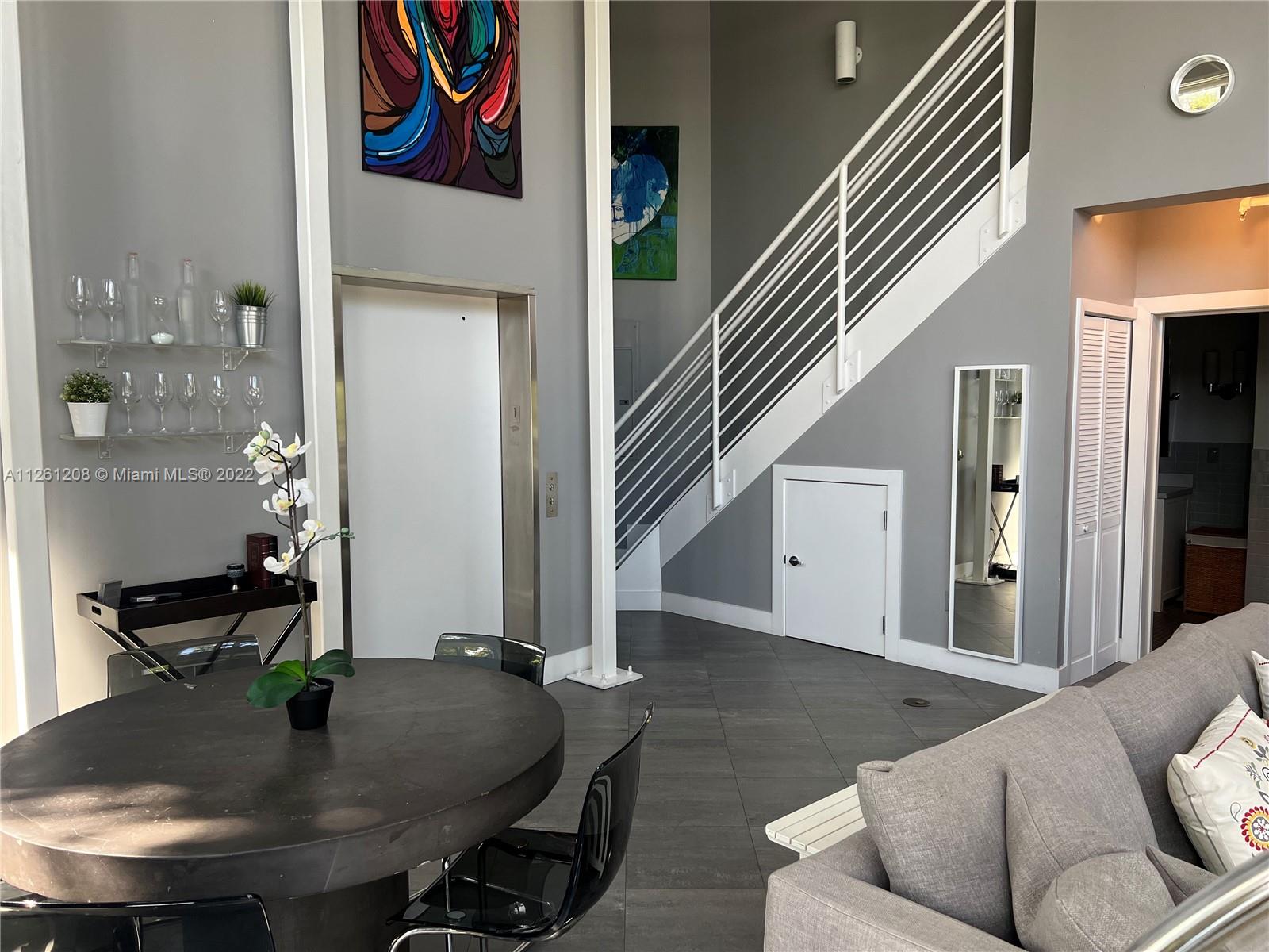 900 4th Street, Unit 2 Miami Beach, FL 33139 - Photo 5 of 15 a dining room with furniture and wooden floor