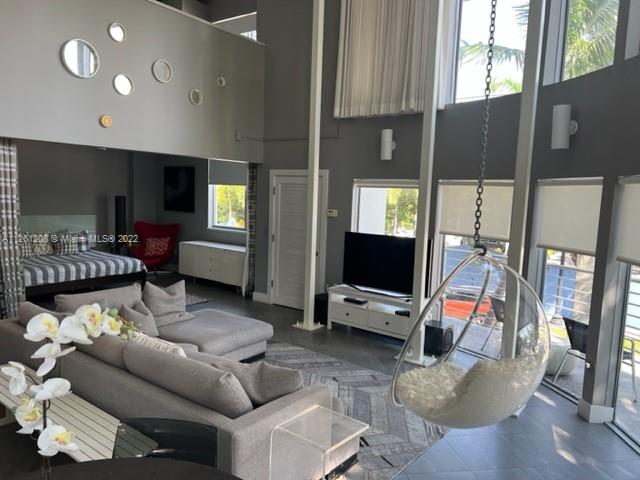 900 4th Street, Unit 2 Miami Beach, FL 33139 - Photo 7 of 15 a living room with furniture gym equipment and a flat screen tv