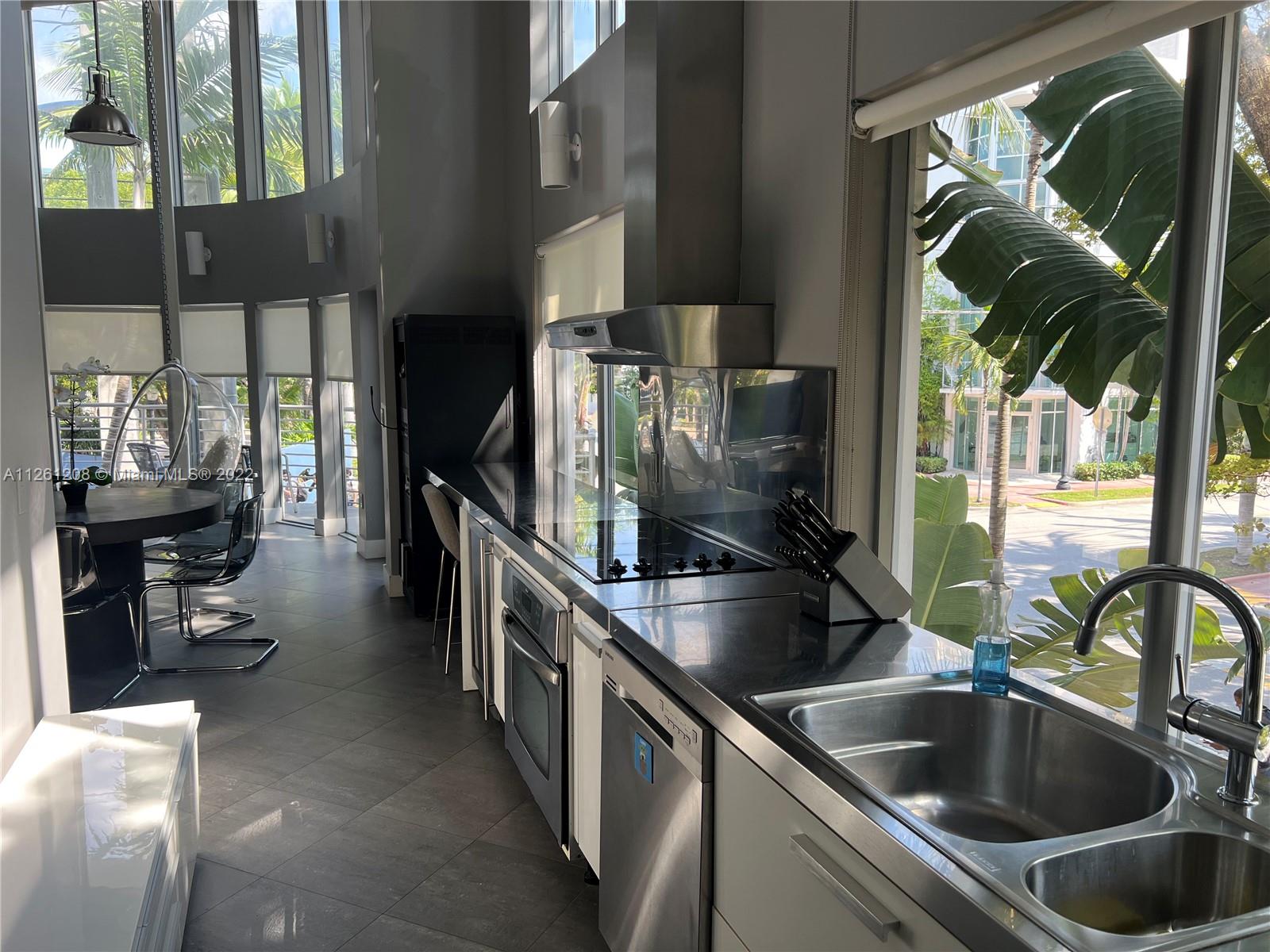 900 4th Street, Unit 2 Miami Beach, FL 33139 - Photo 8 of 15 a kitchen with a sink and refrigerator