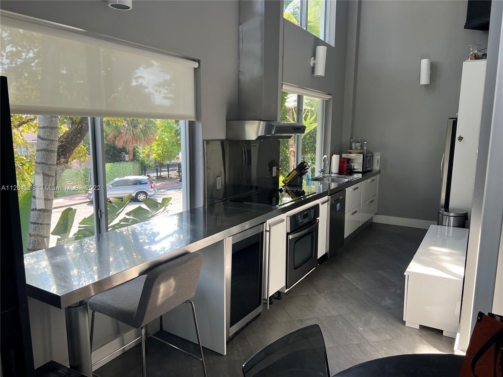 900 4th Street, Unit 2 Miami Beach, FL 33139 - Photo 9 of 15 a kitchen with a table chairs sink and stove