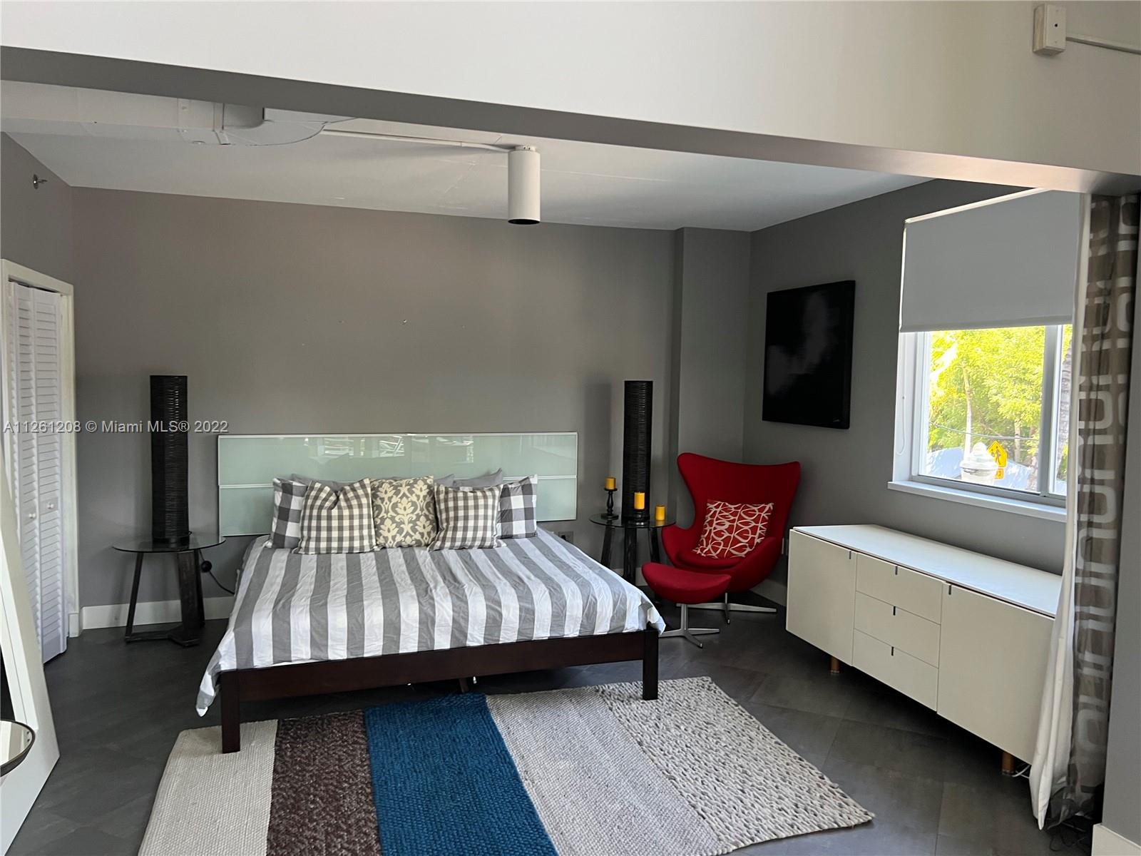 900 4th Street, Unit 2 Miami Beach, FL 33139 - Photo 10 of 15 a bedroom with a bed and a couch