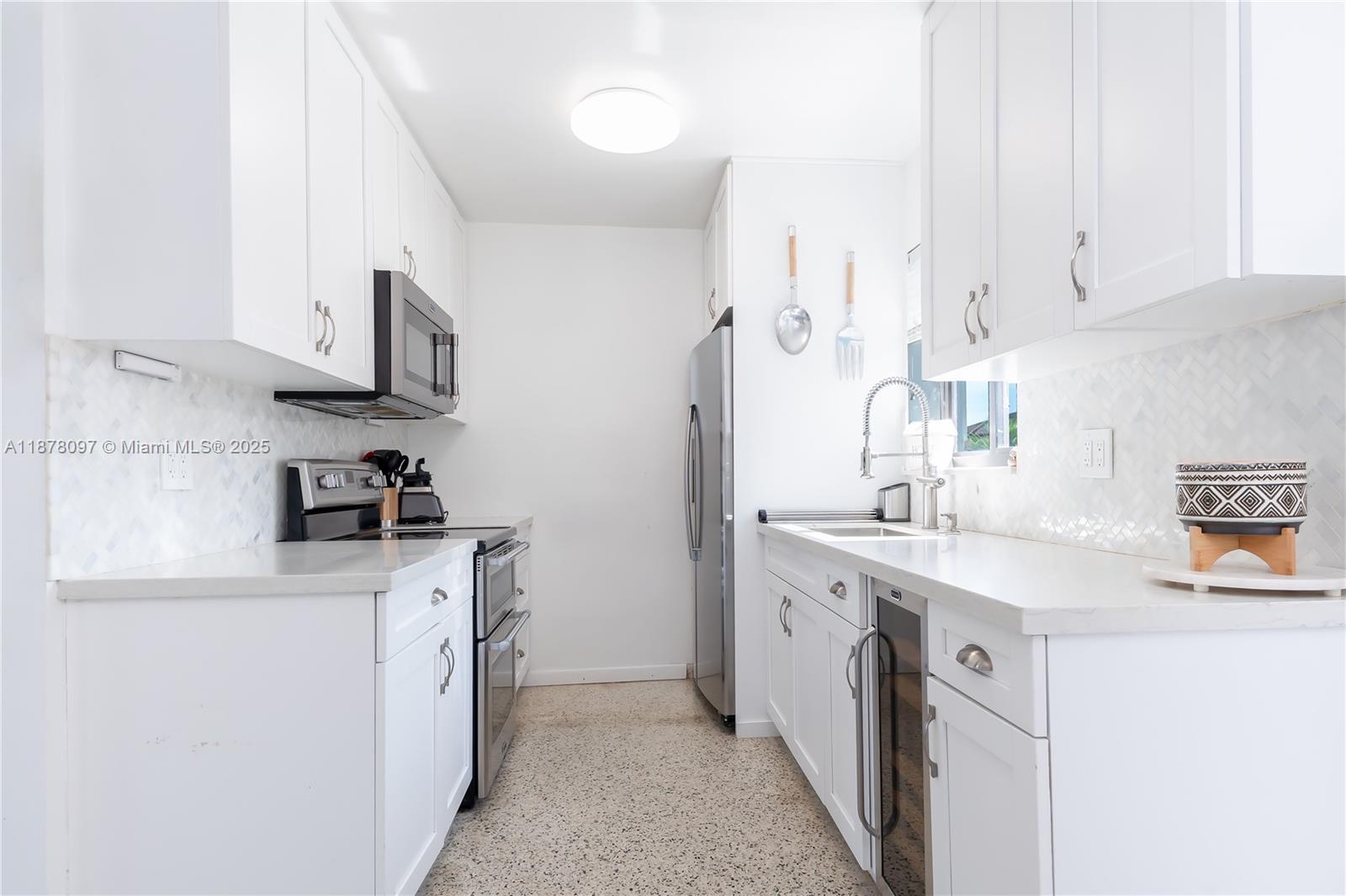 10370 Southwest 34th Street Miami, FL 33165 - Photo 15 of 47 a kitchen with stainless steel appliances granite countertop a sink stove and refrigerator