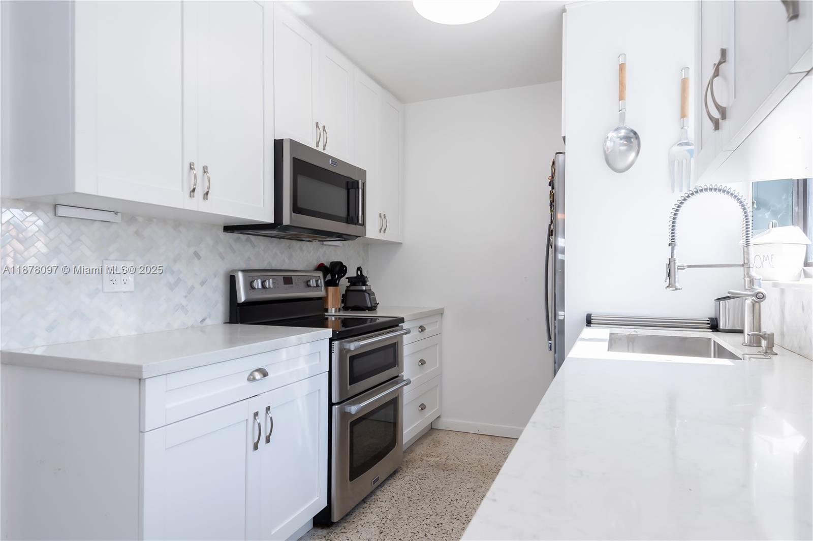 10370 Southwest 34th Street Miami, FL 33165 - Photo 19 of 47 a kitchen with stainless steel appliances granite countertop a sink and a stove