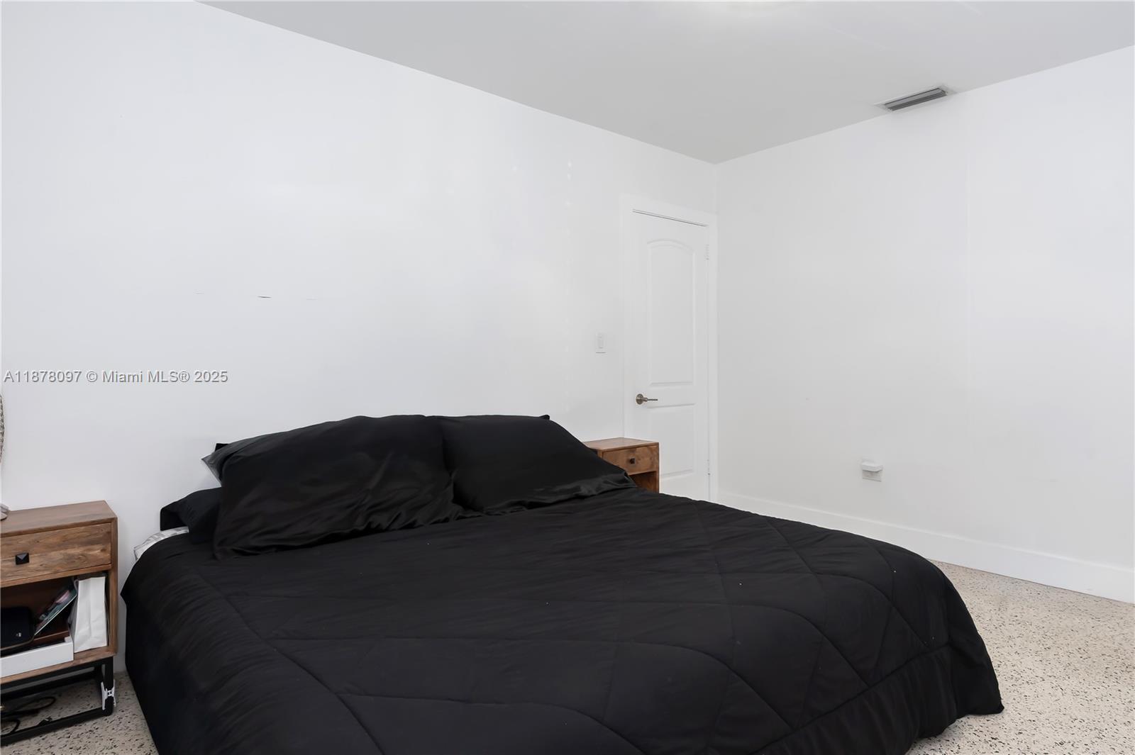10370 Southwest 34th Street Miami, FL 33165 - Photo 20 of 47 a bedroom with a bed and a night stand