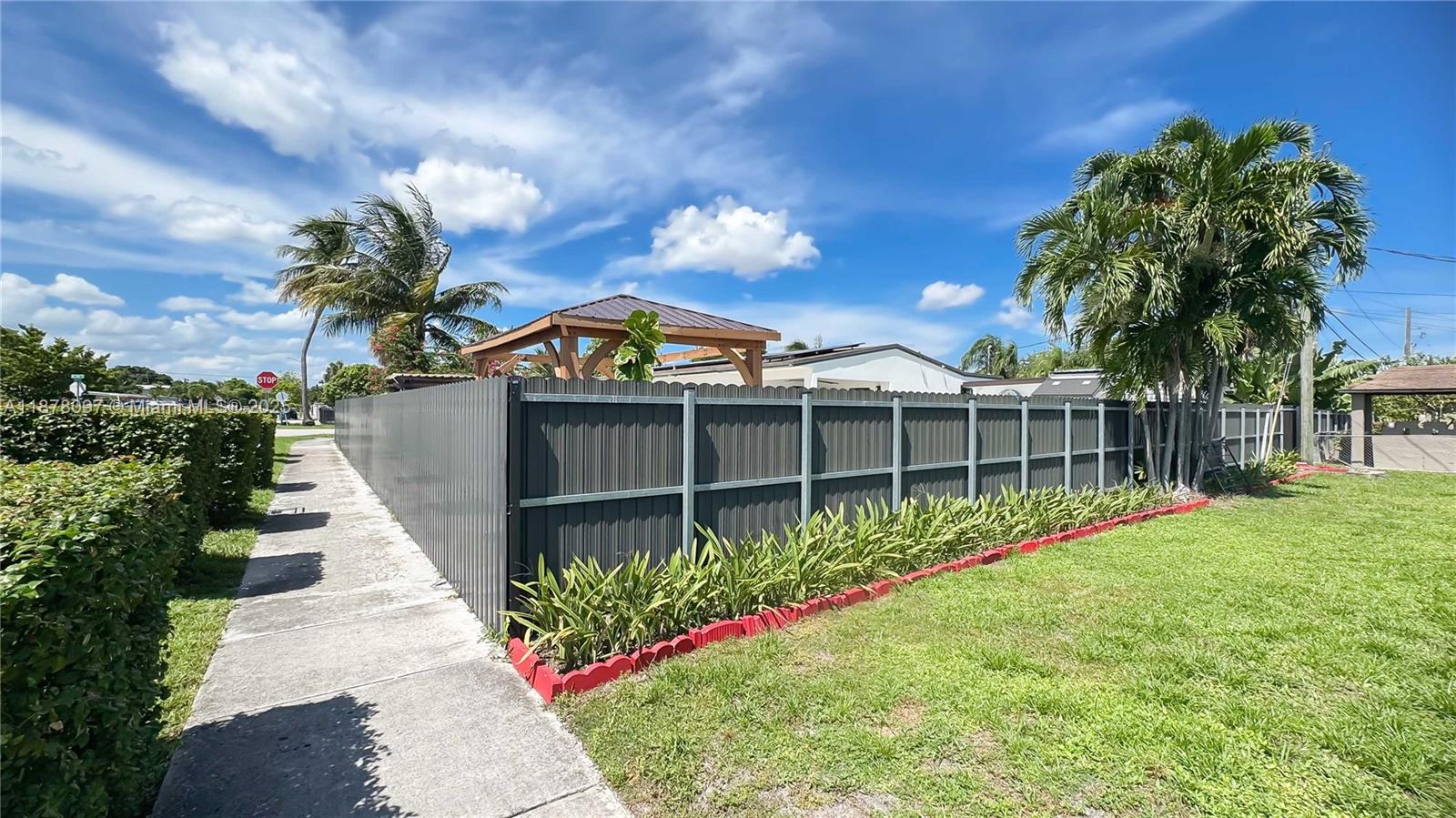 10370 Southwest 34th Street Miami, FL 33165 - Photo 6 of 47 a front view of a house with a yard and potted plants