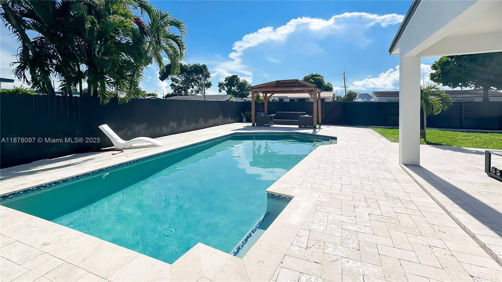 10370 Southwest 34th Street Miami, FL 33165 - Photo 10 of 47 a view of a swimming pool with a lounge chairs