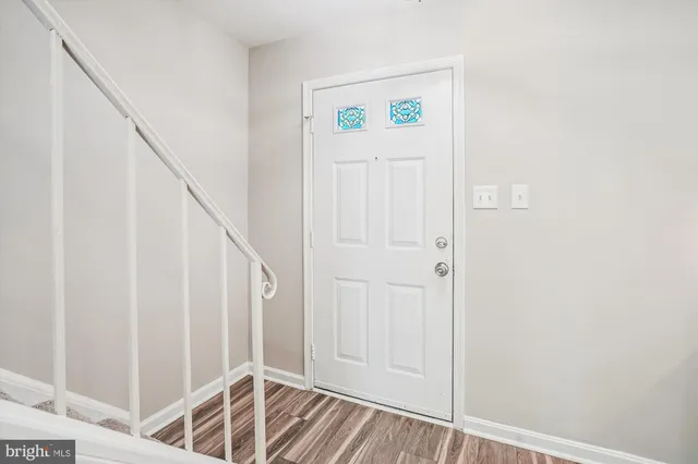 a view of front door with wooden floor