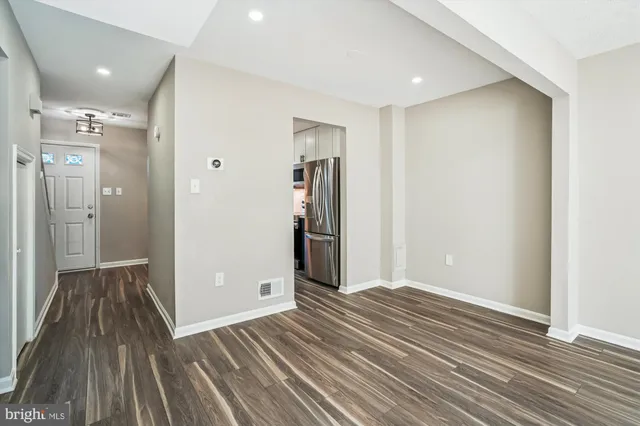 a view of hallway with wooden floor