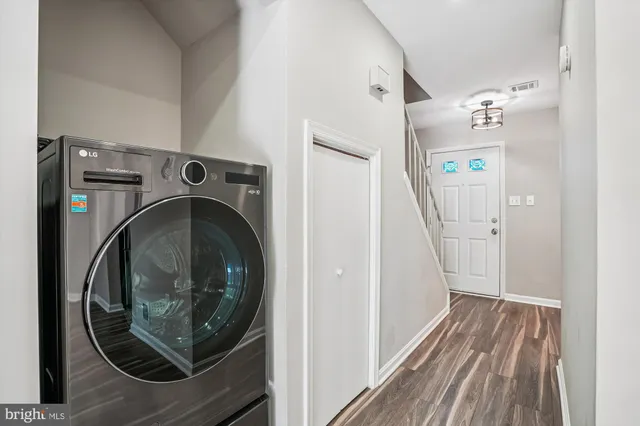 a view of a hallway with washer and dryer