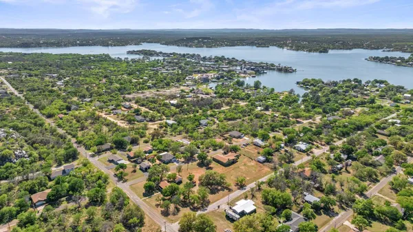 an aerial view of green landscape with trees houses and mountain view