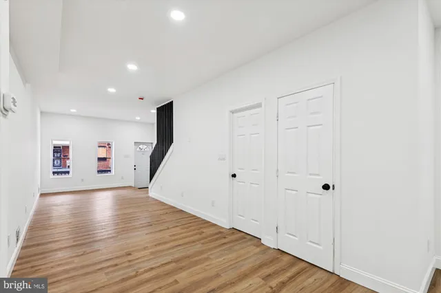 a view of an empty room with wooden floor