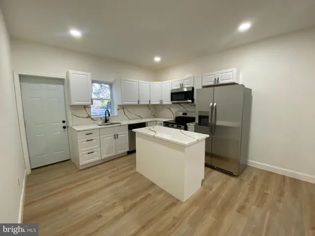 a kitchen that has a sink and a stove in it