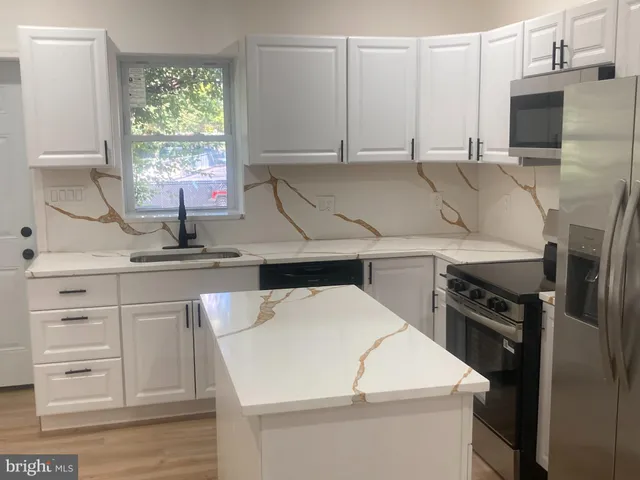 a kitchen with a appliances and a sink