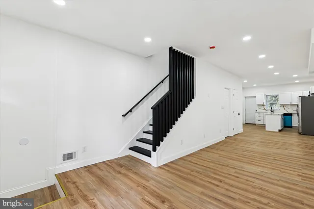 a view of entryway and hall with wooden floor
