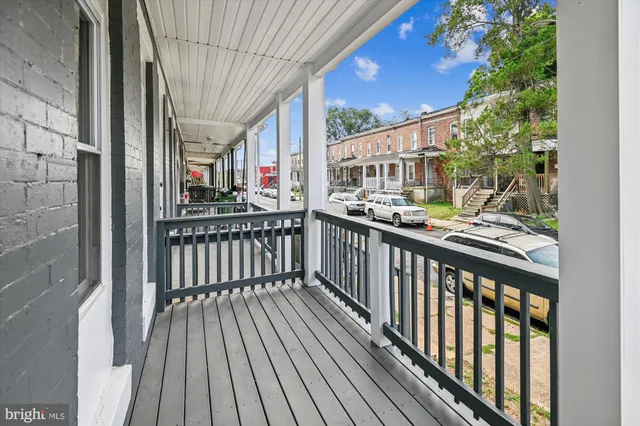 a view of a balcony with wooden floor
