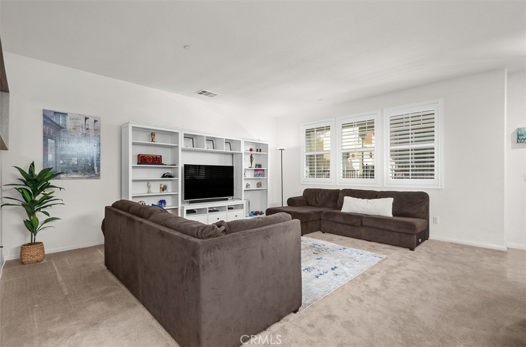 646 South Fillmore Avenue Rialto, CA 92376 - Photo 13 of 46 a living room with furniture a flat screen tv and a large window