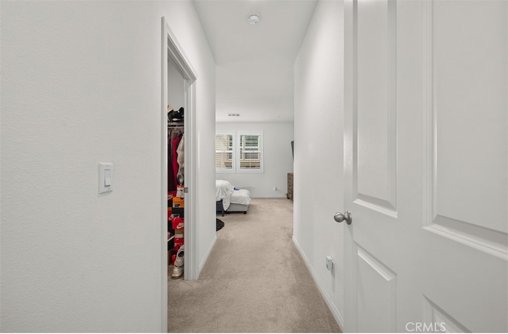 646 South Fillmore Avenue Rialto, CA 92376 - Photo 16 of 46 a view of a hallway with wooden floor and a bathroom