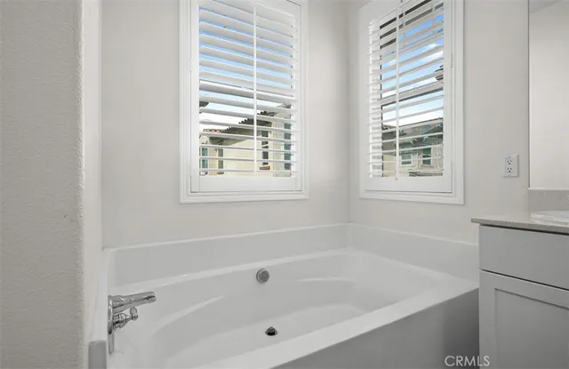 a white bath tub sitting next to a window
