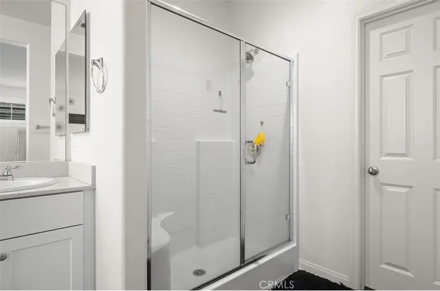 a bathroom with a shower and a sink