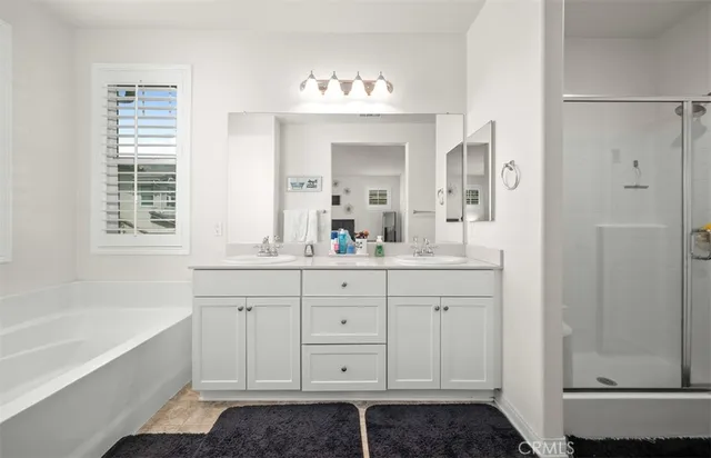 a bathroom with a tub sink and mirror