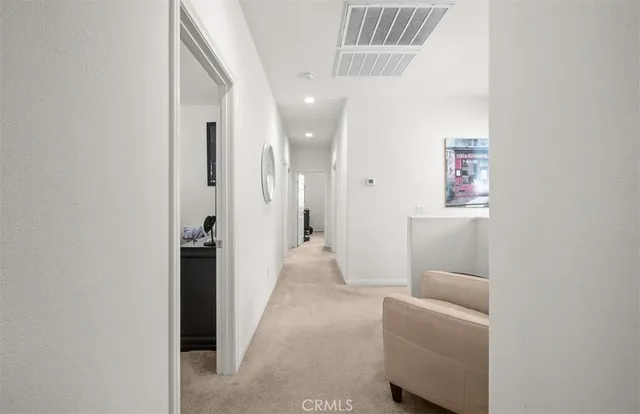 a view of hallway with livingroom and furniture