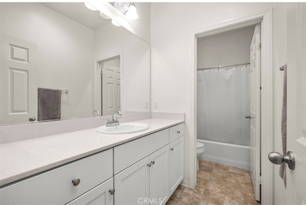 646 South Fillmore Avenue Rialto, CA 92376 - Photo 31 of 46 a bathroom with a sink and a mirror
