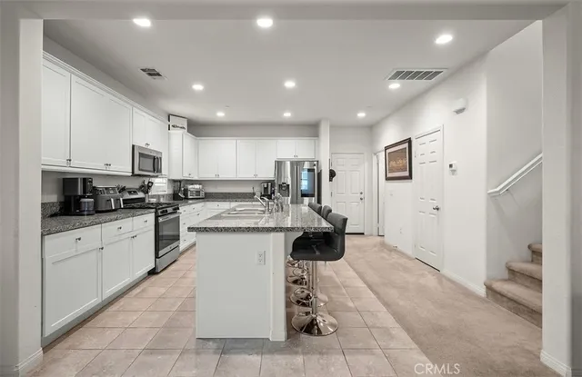 a kitchen with a sink cabinets and window