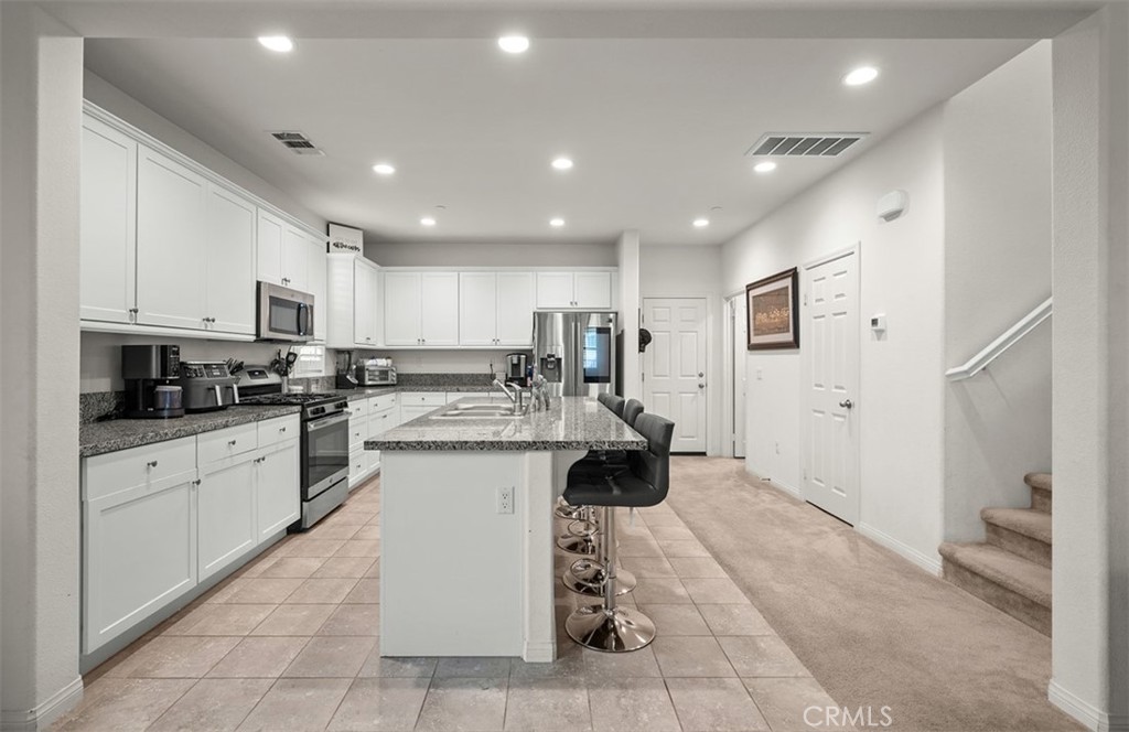646 South Fillmore Avenue Rialto, CA 92376 - Photo 7 of 46 a kitchen with a sink cabinets and window