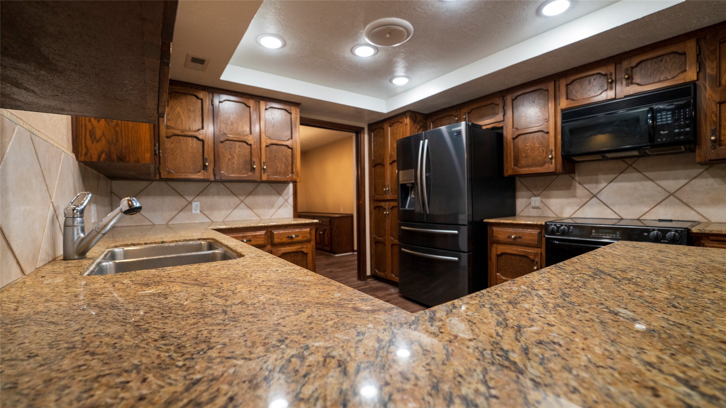 2105 Yokley Road Rockdale, TX 76567 - Photo 13 of 38 a kitchen with stainless steel appliances kitchen island granite countertop a refrigerator oven a sink and dishwasher