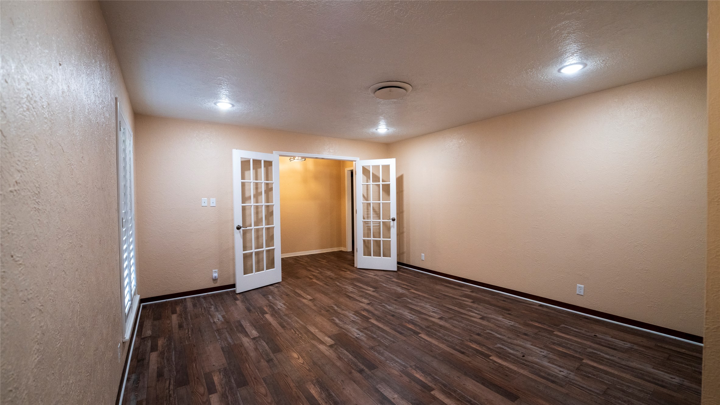2105 Yokley Road Rockdale, TX 76567 - Photo 15 of 38 an empty room with wooden floor and windows