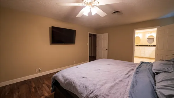 a bedroom with a bed and a flat screen tv
