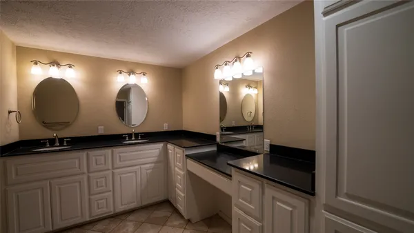 a bathroom with a double vanity sink and a mirror