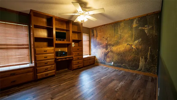a view of room with window and wooden floor