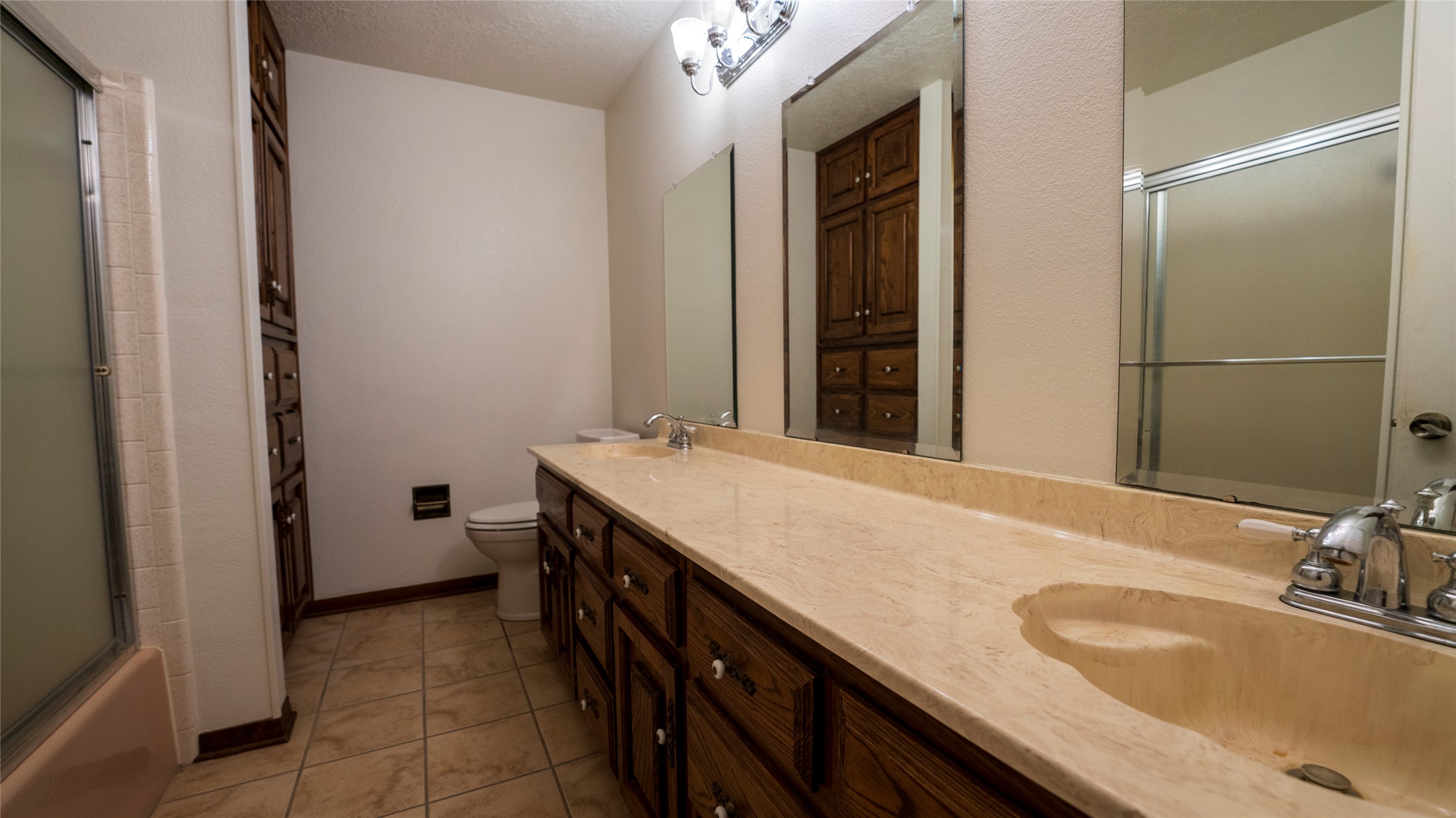 2105 Yokley Road Rockdale, TX 76567 - Photo 28 of 38 a bathroom with a granite countertop sink a mirror and a bathtub