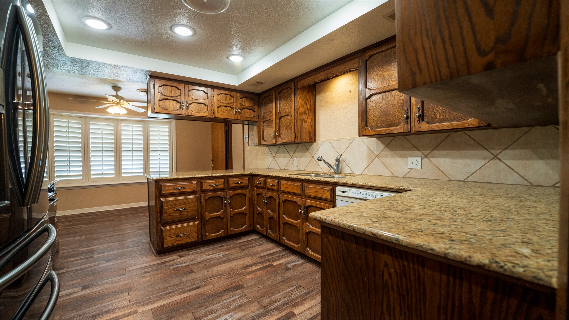 2105 Yokley Road Rockdale, TX 76567 - Photo 4 of 38 a kitchen with a sink and wooden cabinets