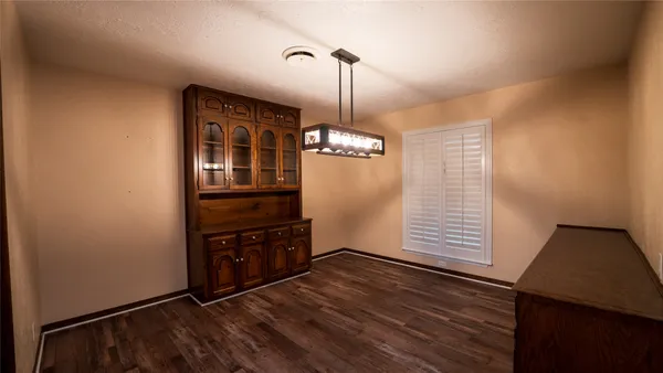 a view of a room with wooden floor