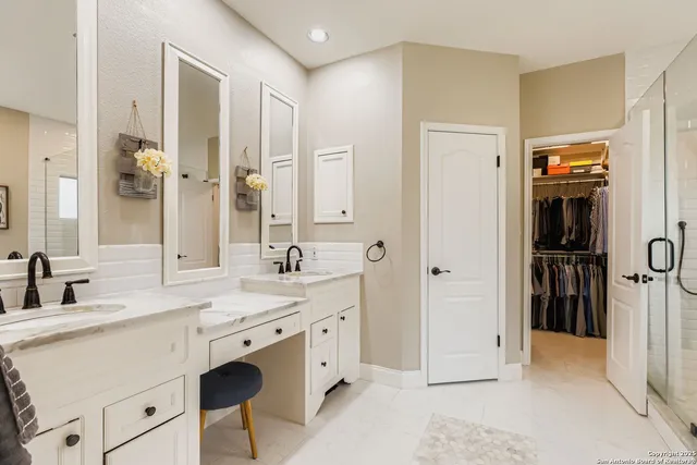 a spacious bathroom with a shower sink and mirror