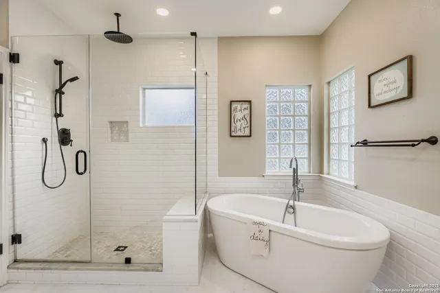 a bathroom with a bathtub and a shower
