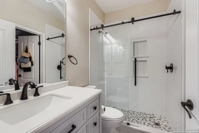a bathroom with a sink toilet and shower