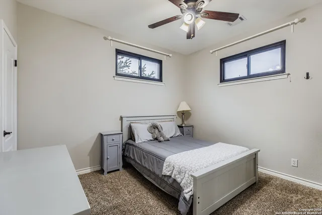 a bedroom with a bed and painting on the wall