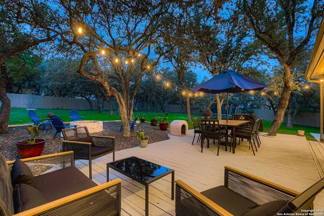 an outdoor sitting area with furniture and umbrella
