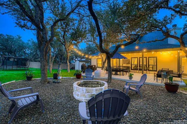 a view of a backyard with sitting area furniture and a fire pit