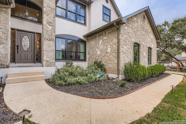 a view of a brick house with potted plants
