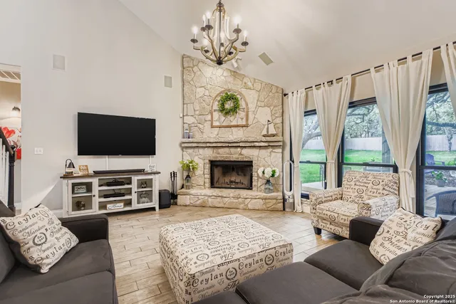a living room with furniture a flat screen tv and a fireplace