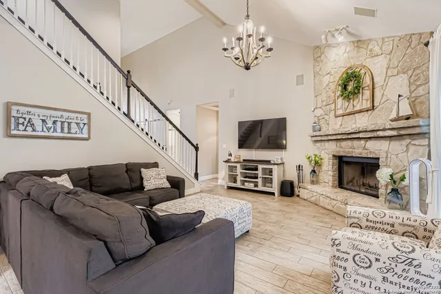 a living room with furniture a fireplace and a flat screen tv