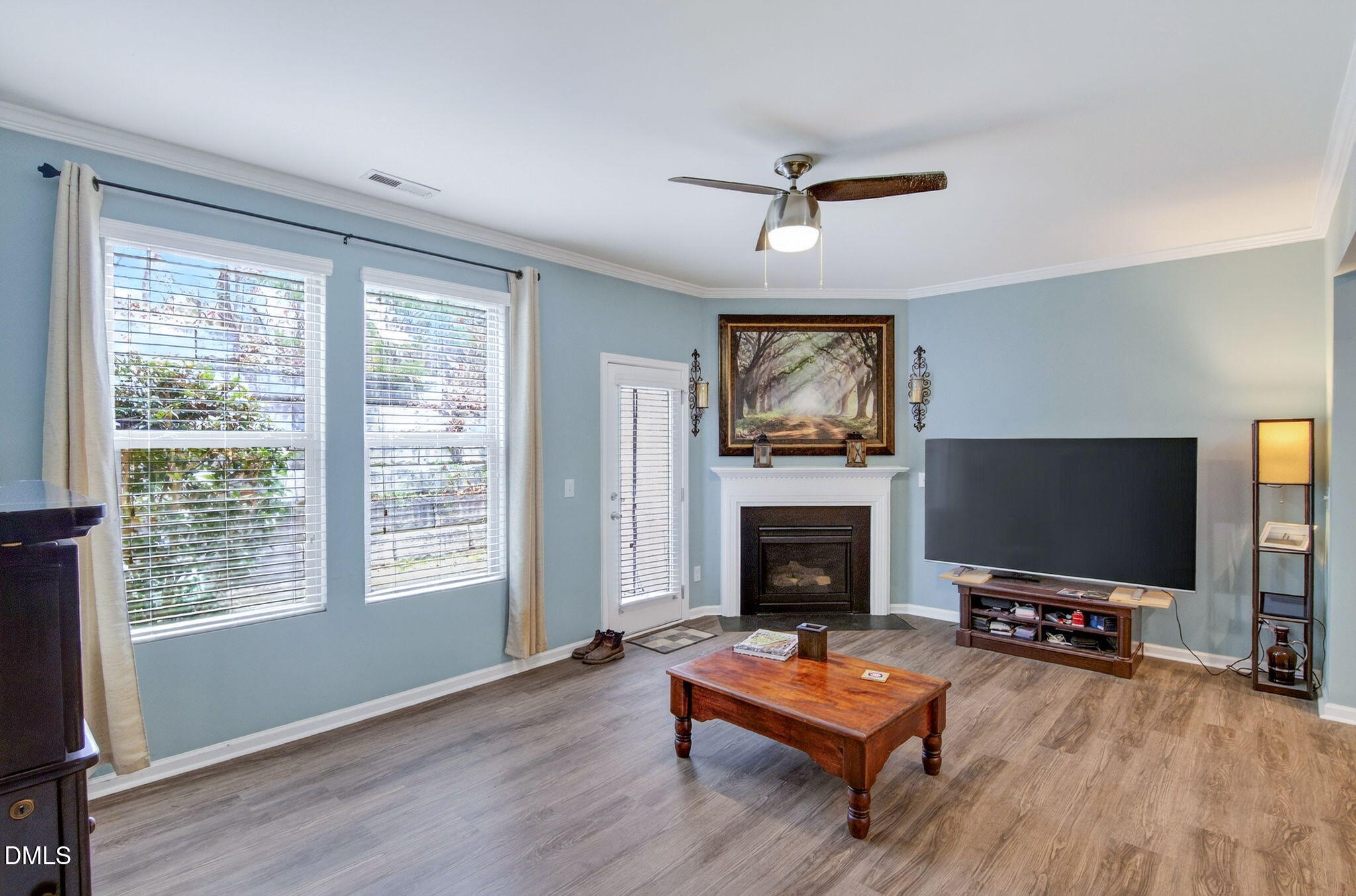 14310 Foxcroft Road Raleigh, NC 27614 - Photo 12 of 32 a living room with furniture a flat screen tv and a fireplace