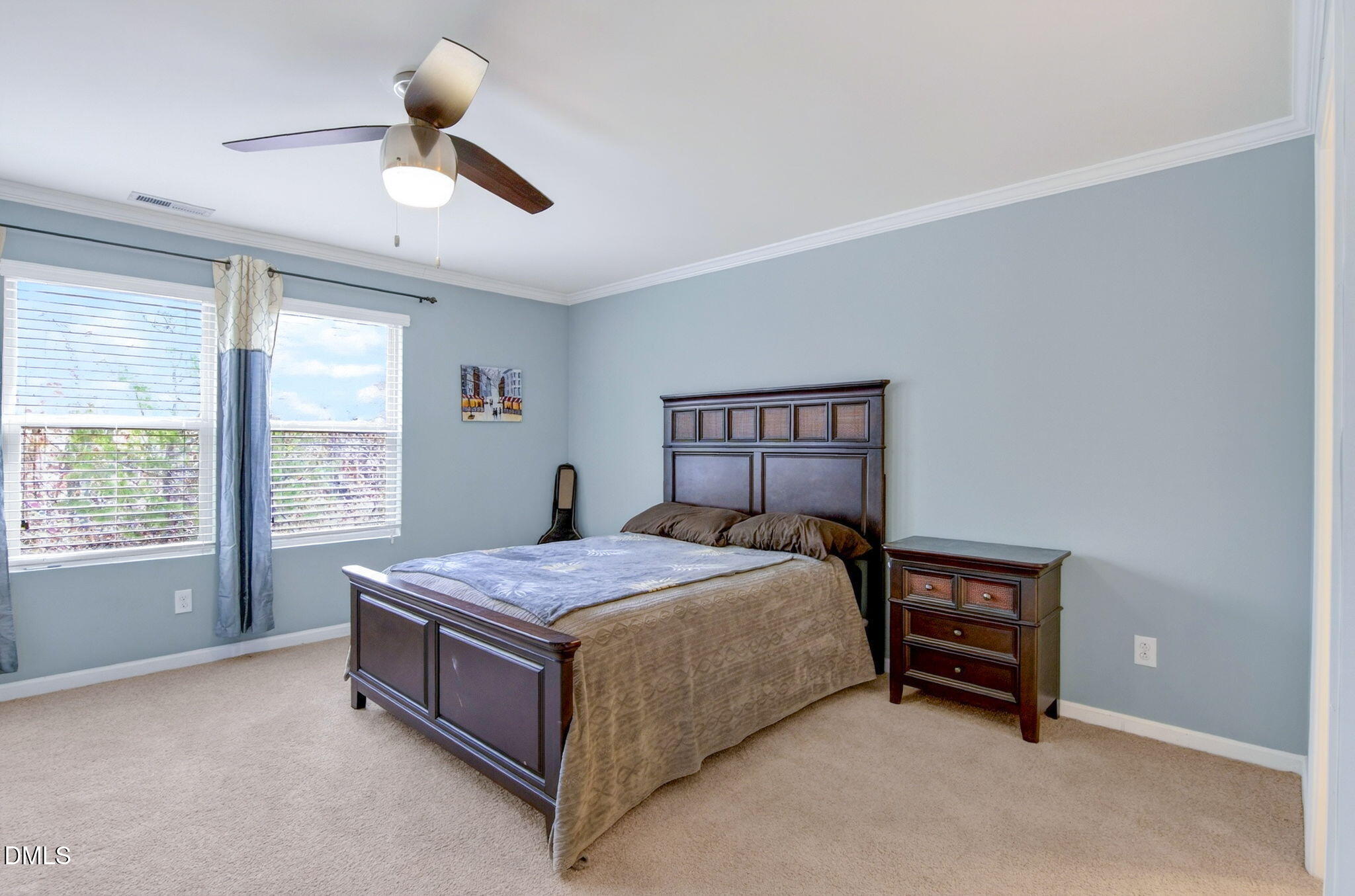 14310 Foxcroft Road Raleigh, NC 27614 - Photo 18 of 32 a bedroom with a bed and a chandelier