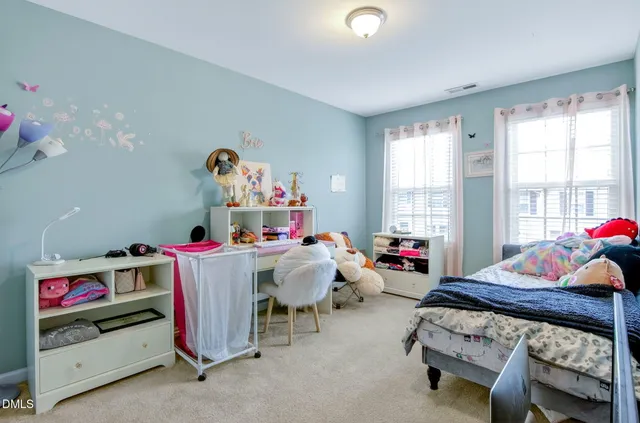 a bed room with a bed and a window