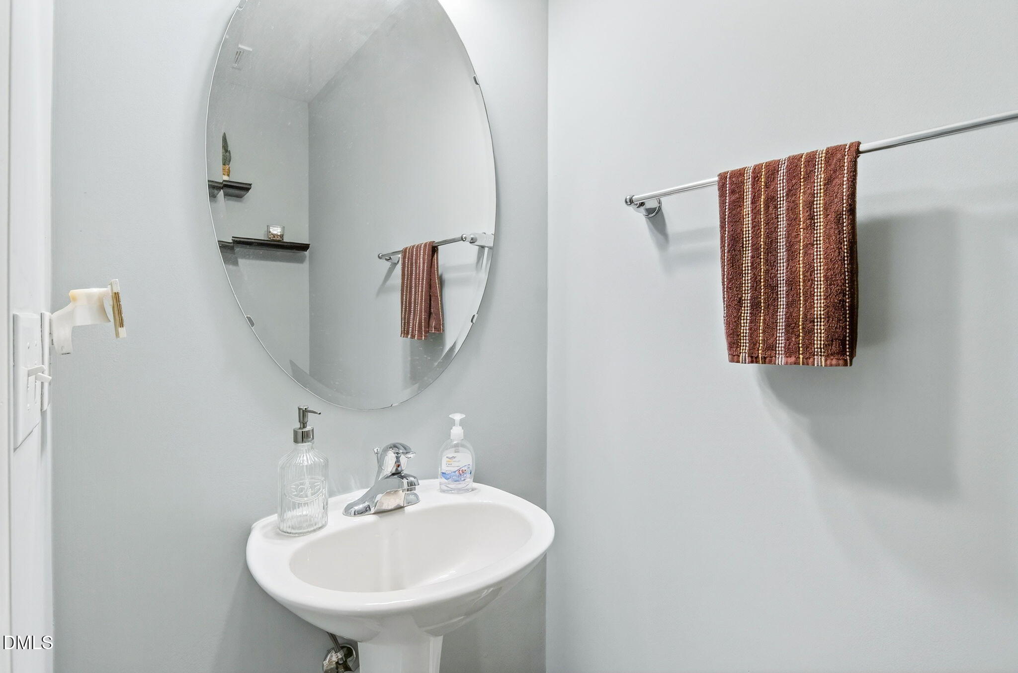 14310 Foxcroft Road Raleigh, NC 27614 - Photo 6 of 32 a bathroom with a sink and a mirror