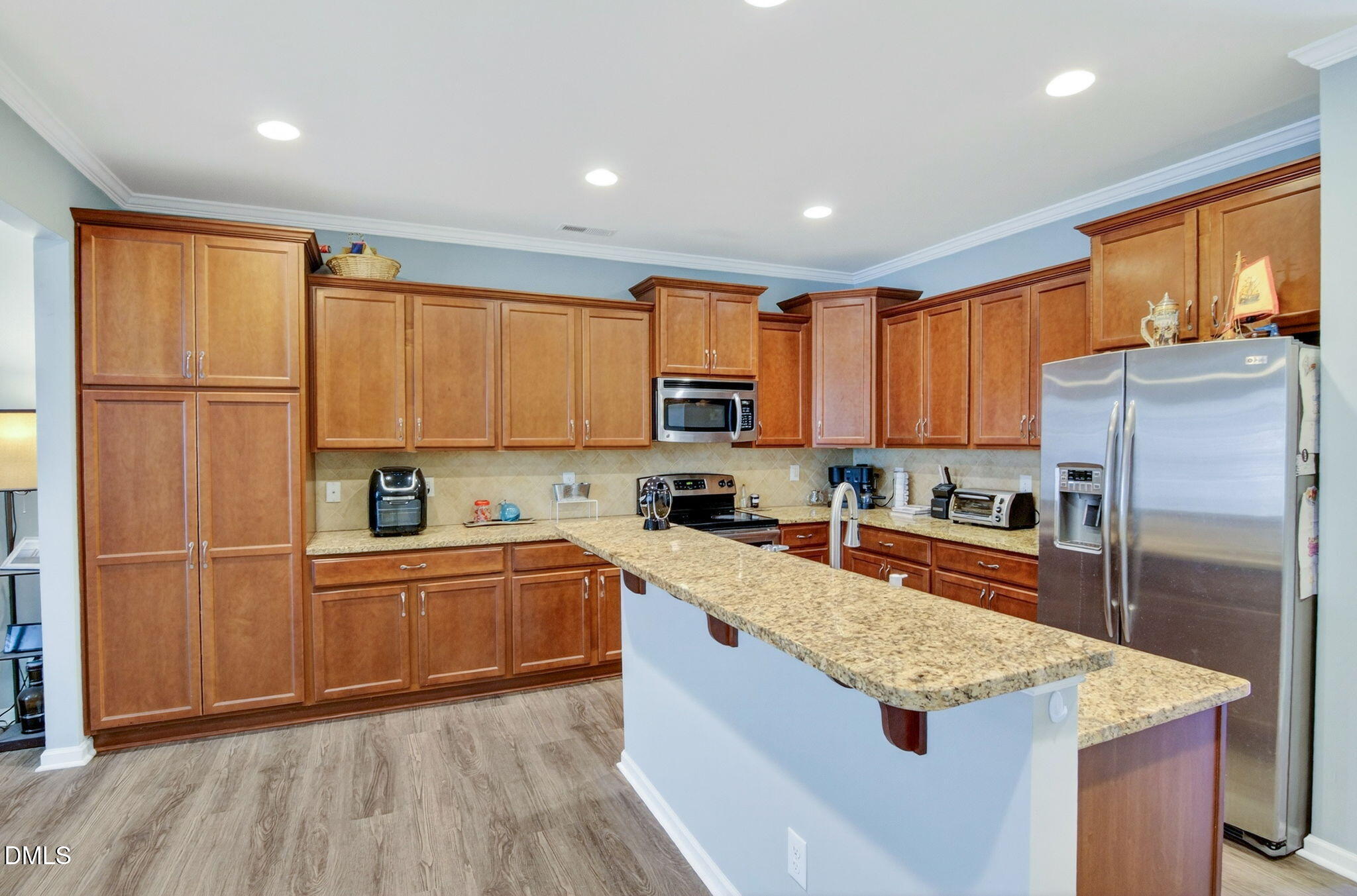 14310 Foxcroft Road Raleigh, NC 27614 - Photo 8 of 32 a kitchen with stainless steel appliances granite countertop a refrigerator a sink dishwasher a stove and white countertops with wooden floor